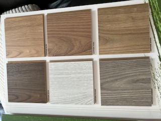Laminate flooring samples in walnut, oak and grey wood finishes